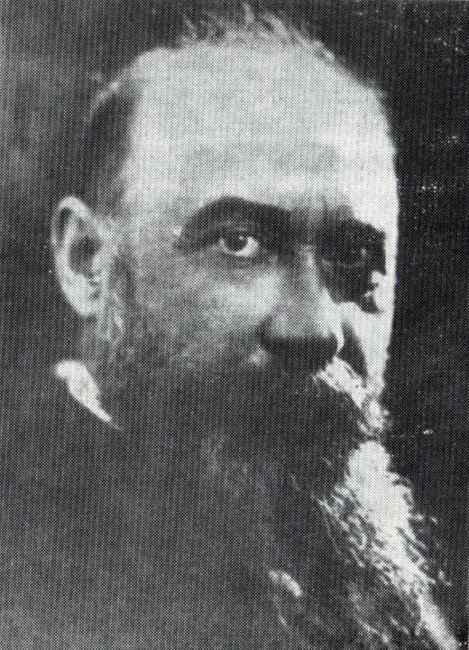 Photographic portrait of Nicolae Iorga in old age, in a suit, with a white beard.