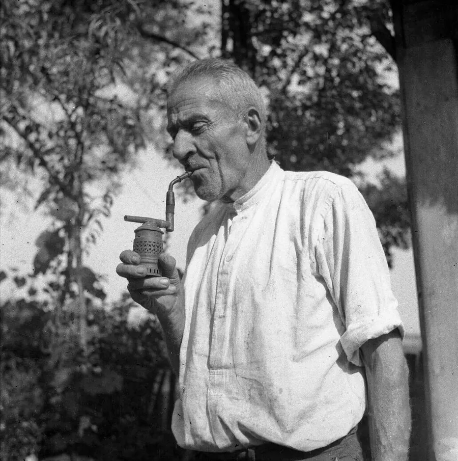 An old beekeeper with his pipe, in a 1952 photograph