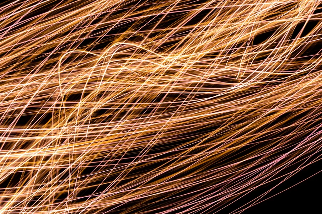 Red and green light traces photographed against black