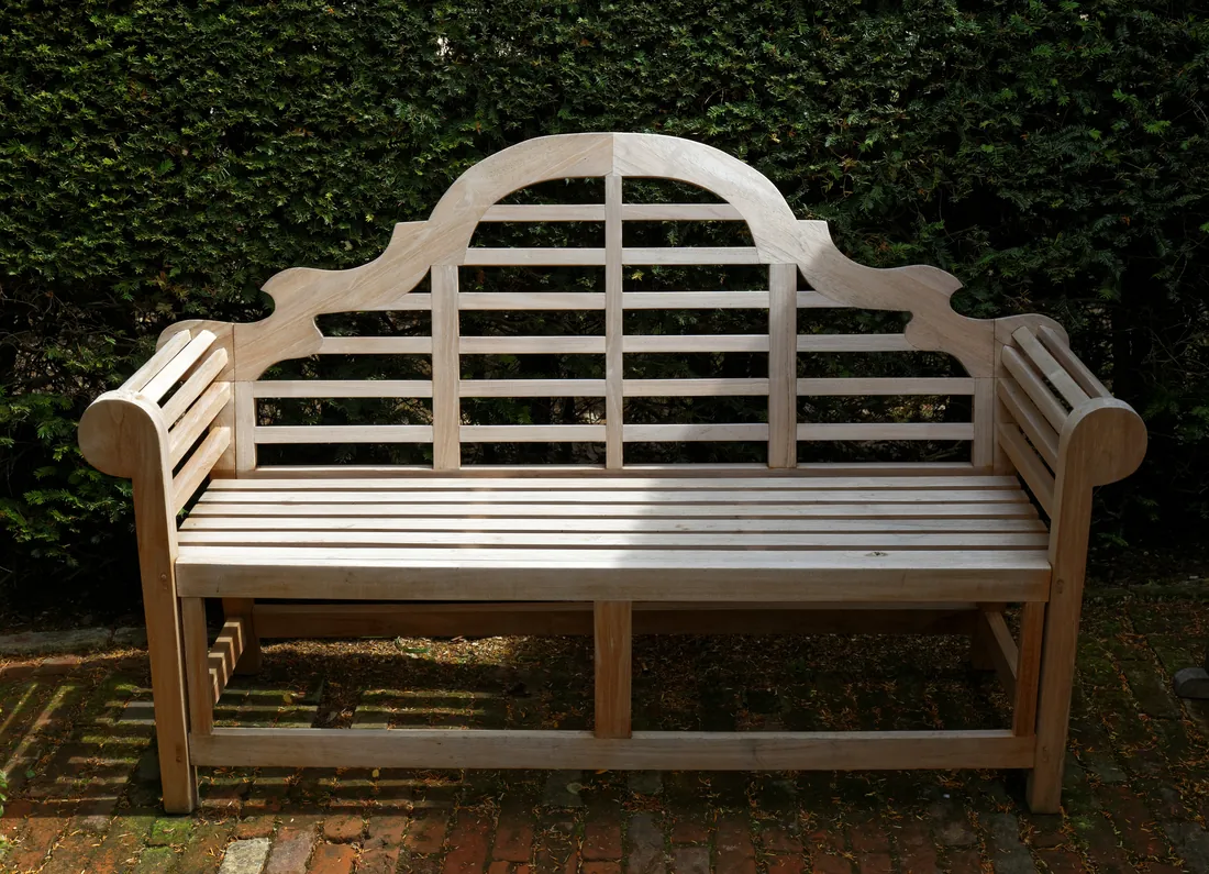 A whole wooden bench in a garden