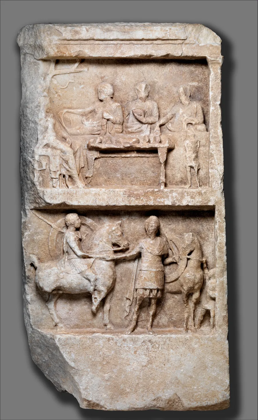 Marble funerary relief with a banquet scene