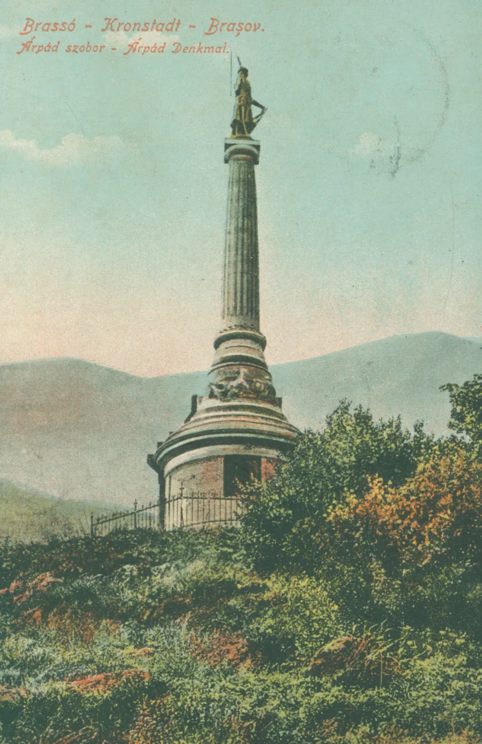 Colour postcard: a tall column with a statue on the summit of Tâmpa (the hill above the old town), with mountains in the distance