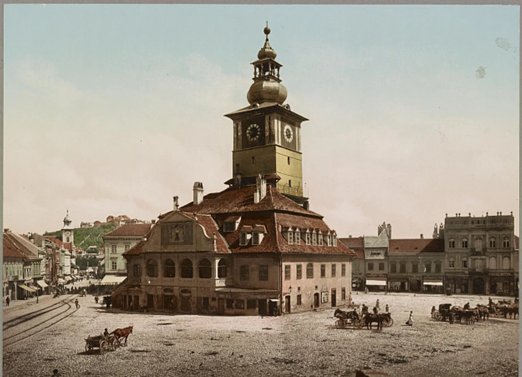 The Council House in Brașov in a photochrom from the Library of Congress, c. 1890–1906: the clock tower, the wide square and carriages
