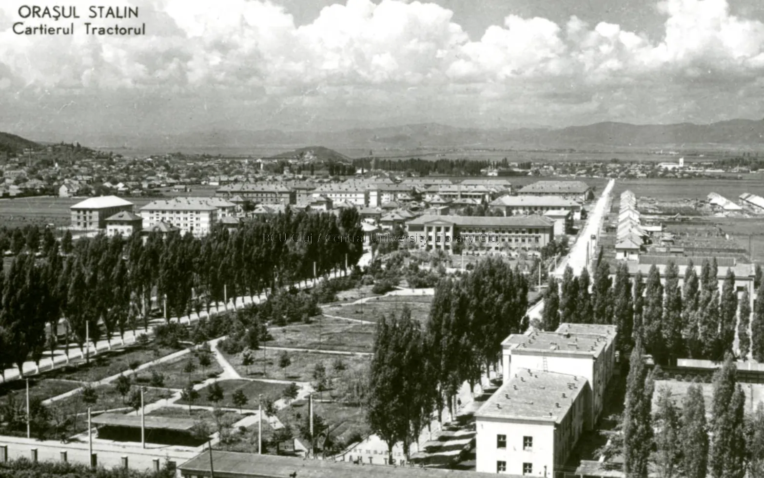 Black-and-white illustrated card: a district of new blocks with straight paths and young trees, seen from above