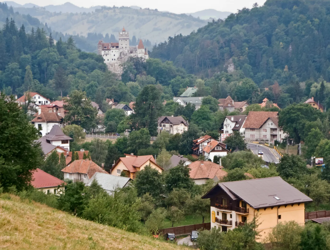 Bran Castle above the village, seen from afar.