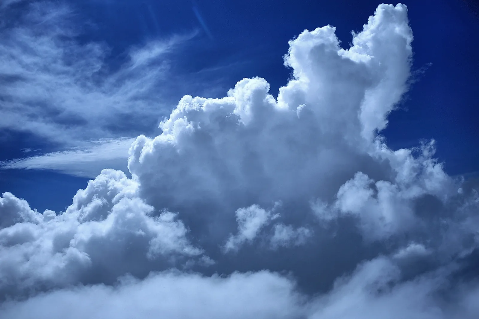 White, puffy cumulus clouds in a blue sky