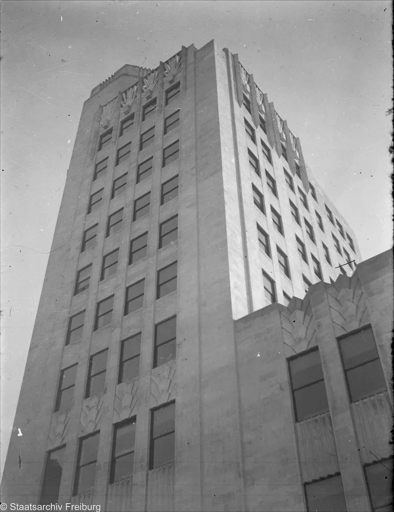 The Telephone Palace seen from below in May 1935: a stepped Art Deco tower against a pale sky.