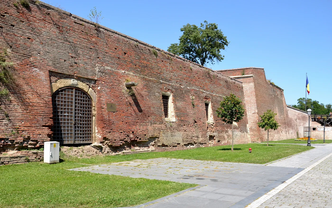Brick wall of the Trinity bastion, with a barred gate.