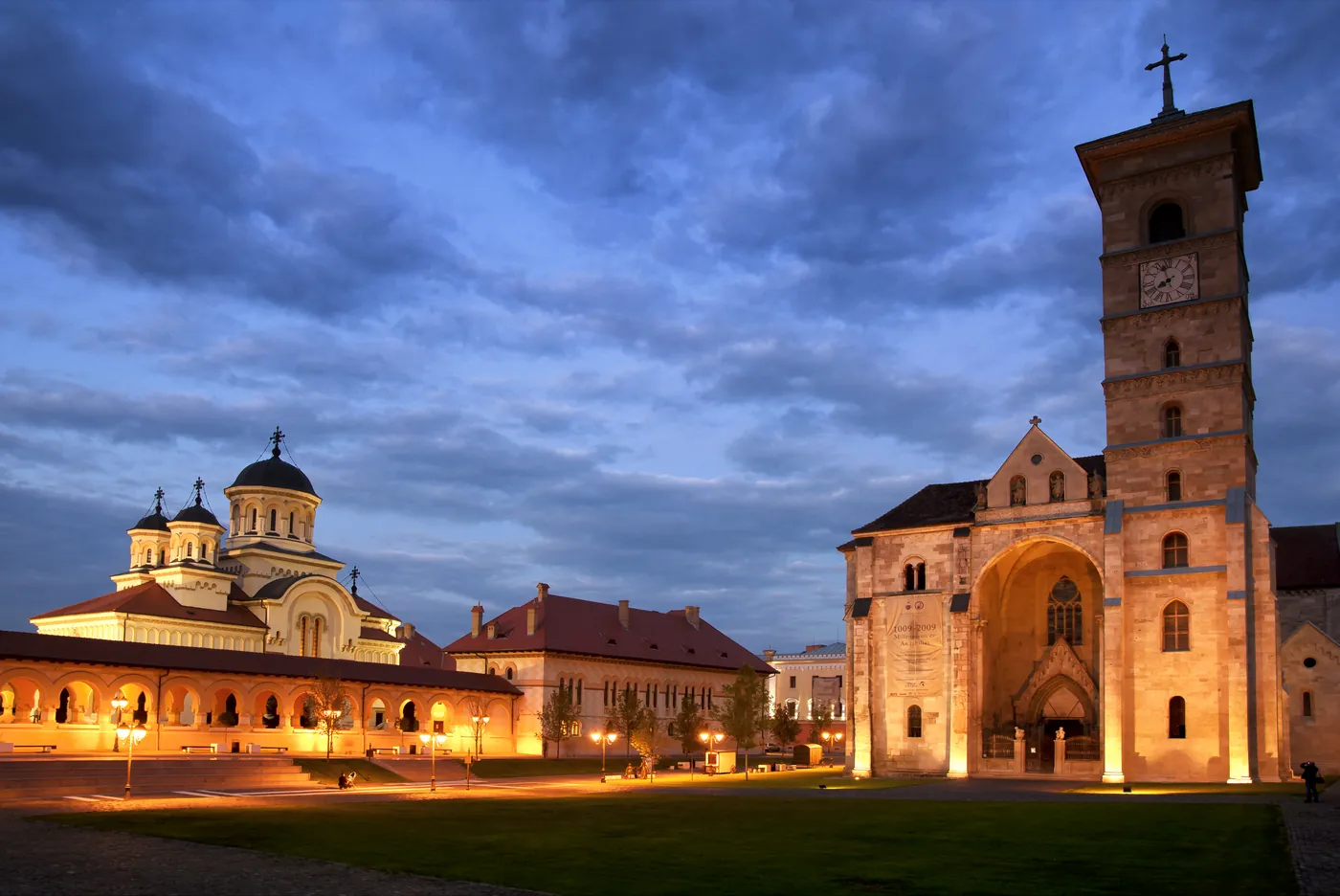 Both cathedrals at dusk: the Coronation one with domes, and St Michael with the tower.