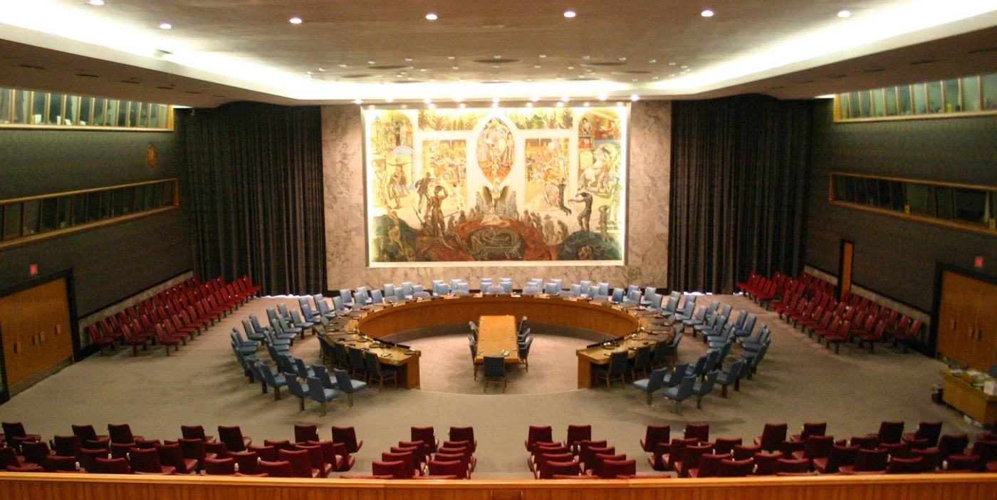 The horseshoe table and rows of seats in the United Nations Security Council chamber in New York.