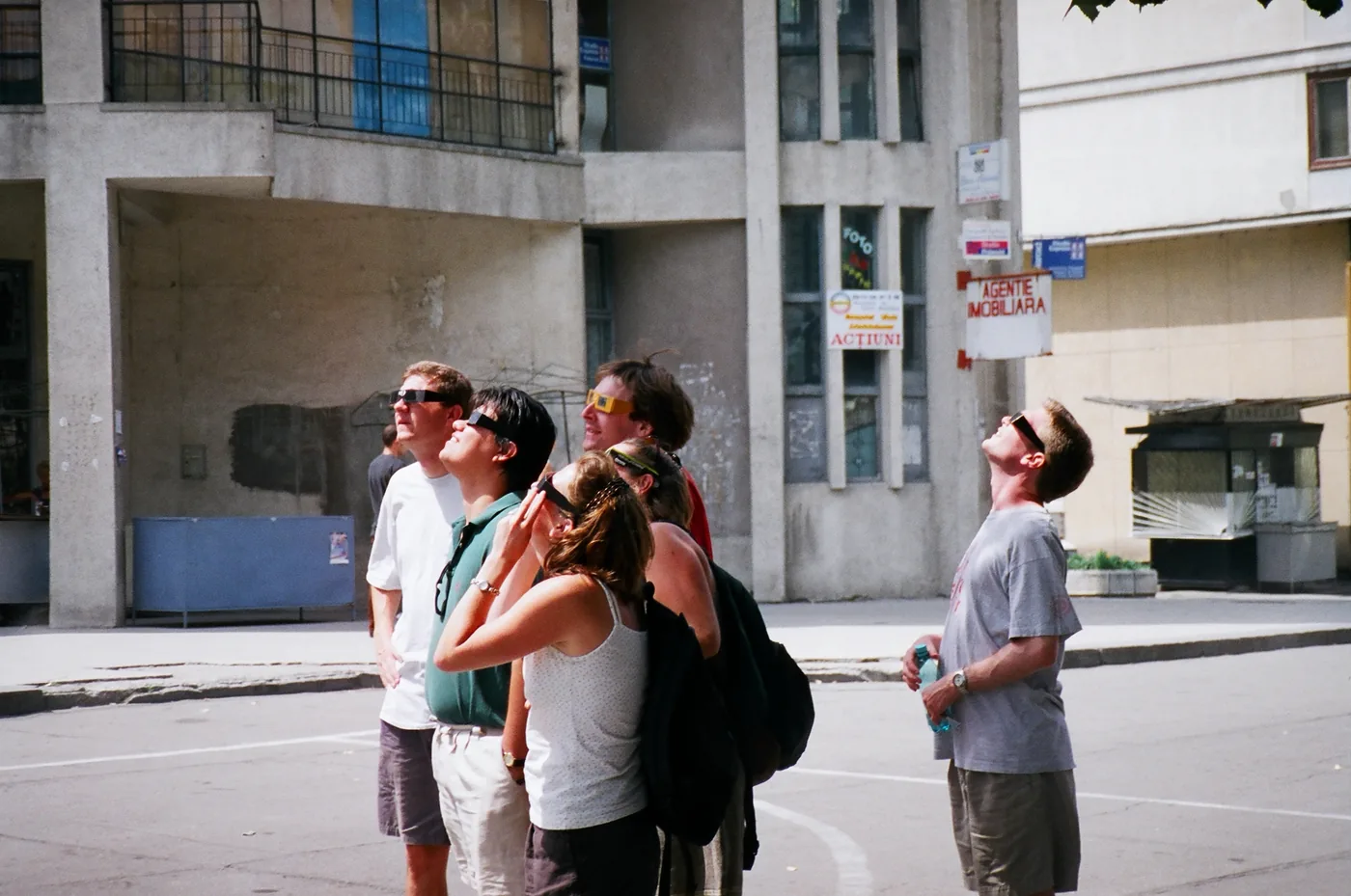 Passers-by in eclipse glasses looking at the Sun, in Romania, on 11 August 1999