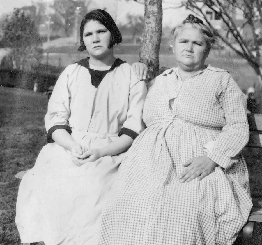 Old photograph of two women seated outdoors.