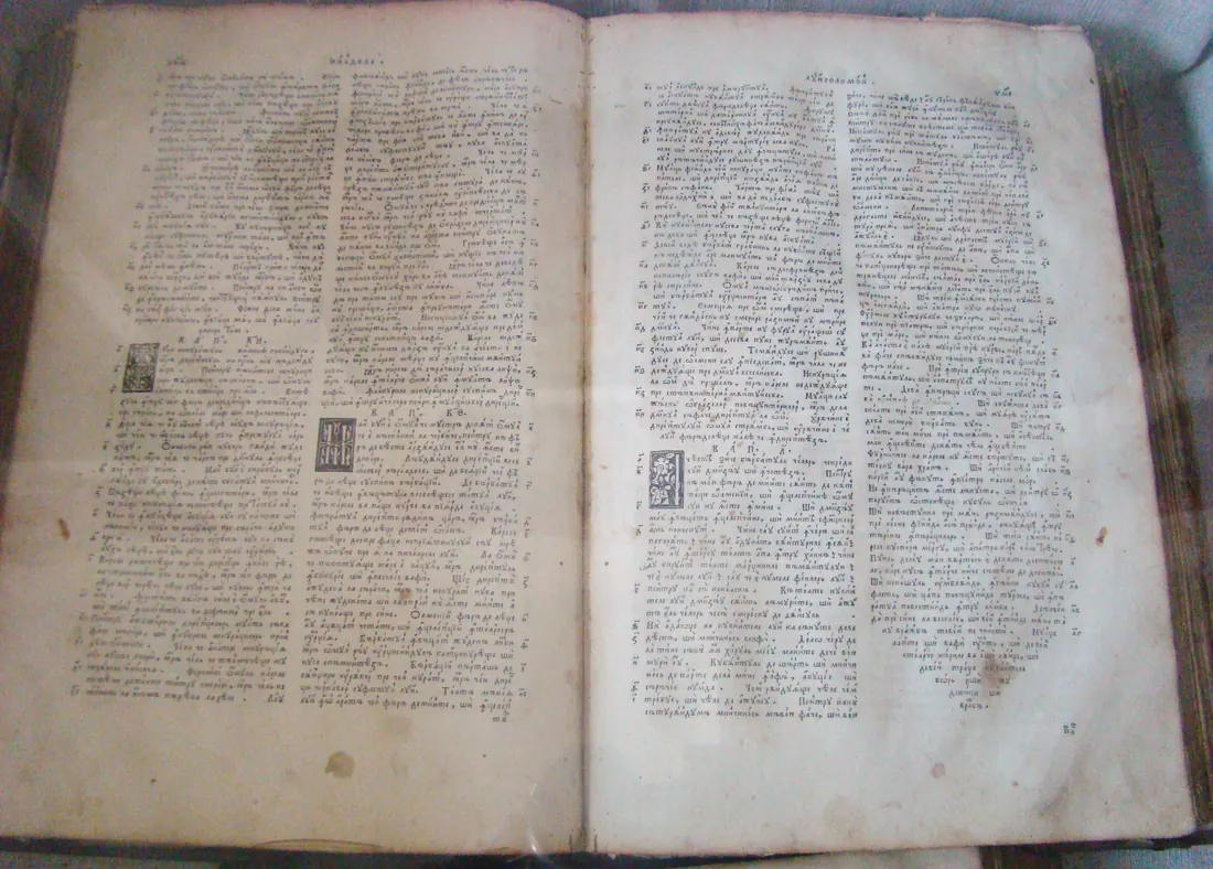An old open Bible, with Romanian Cyrillic text in two columns