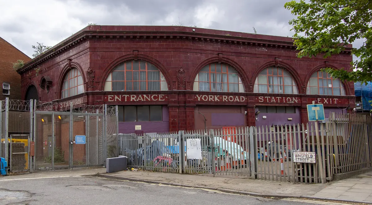The red York Road station building, lettered York Road Station, behind a fence.