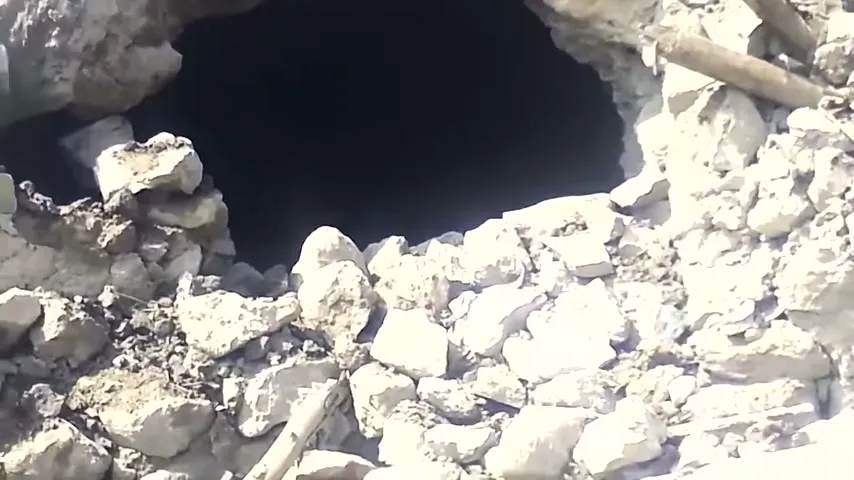 A tunnel opening at the site, from the same footage.