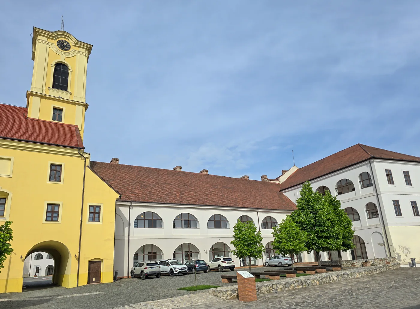 The fortress's inner courtyard today: the yellow church and the arcaded palace