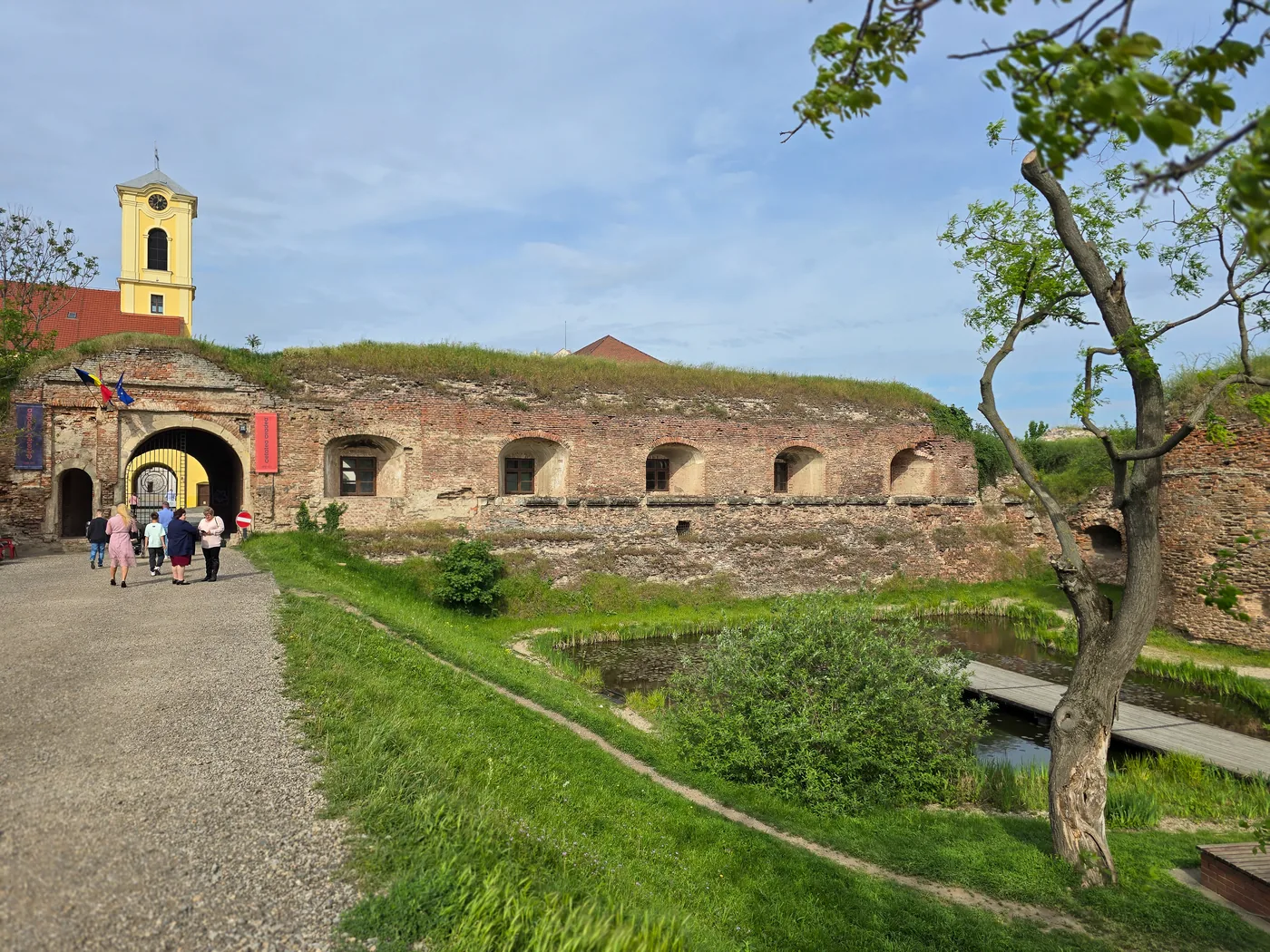 The fortress gate today, with brick walls and the green moat