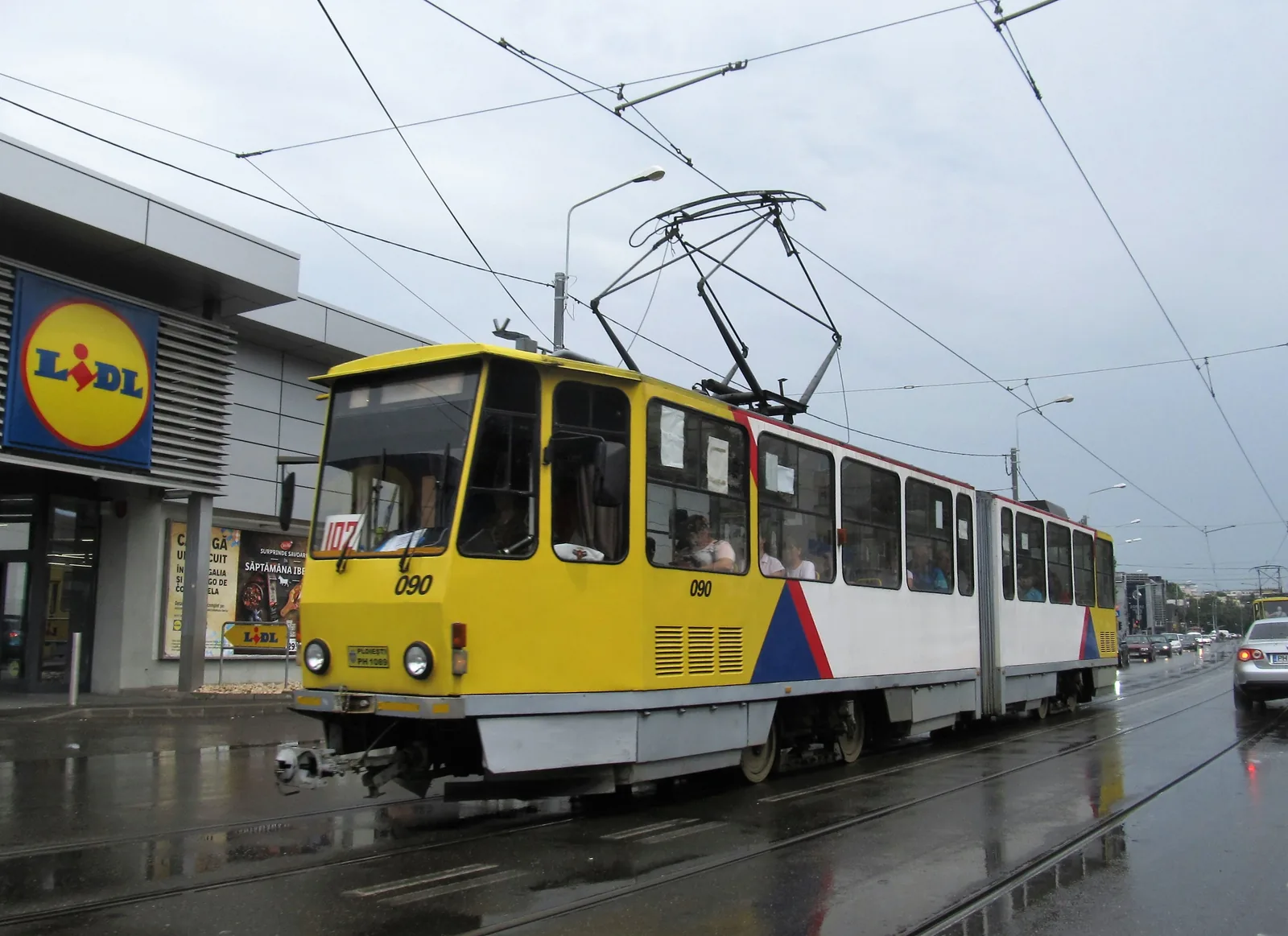 A Tatra tram with passengers on a street in Ploiești