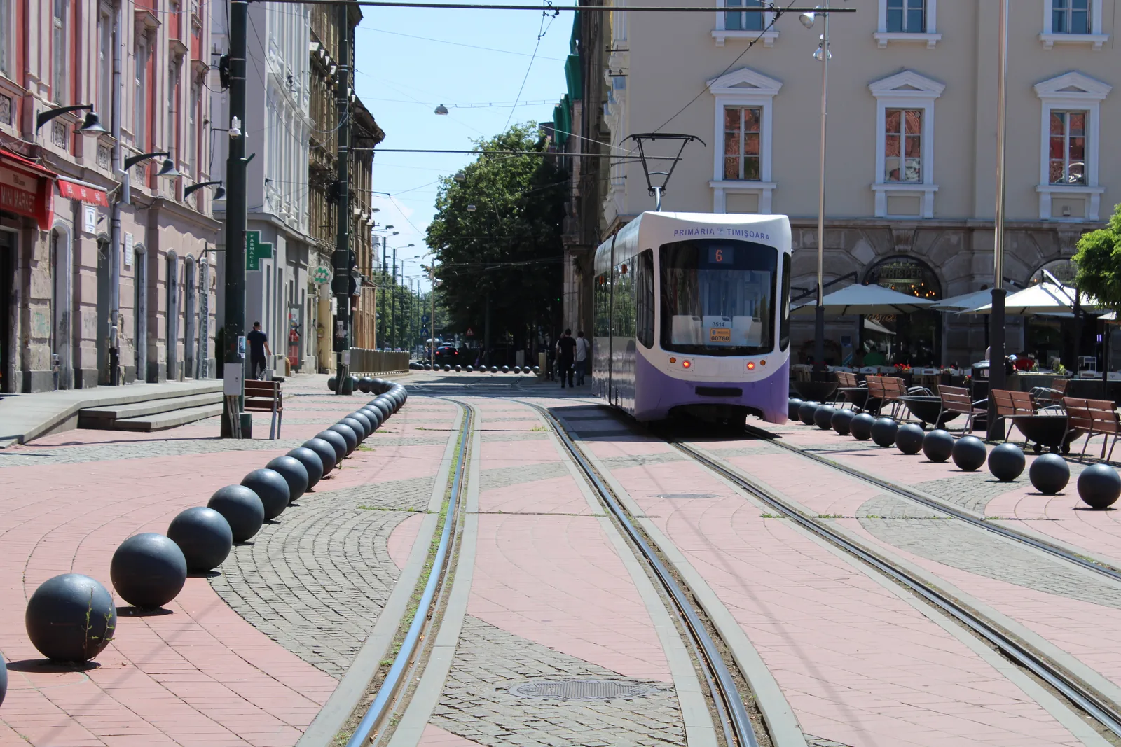 A modern tram running on a pedestrian street in Timișoara
