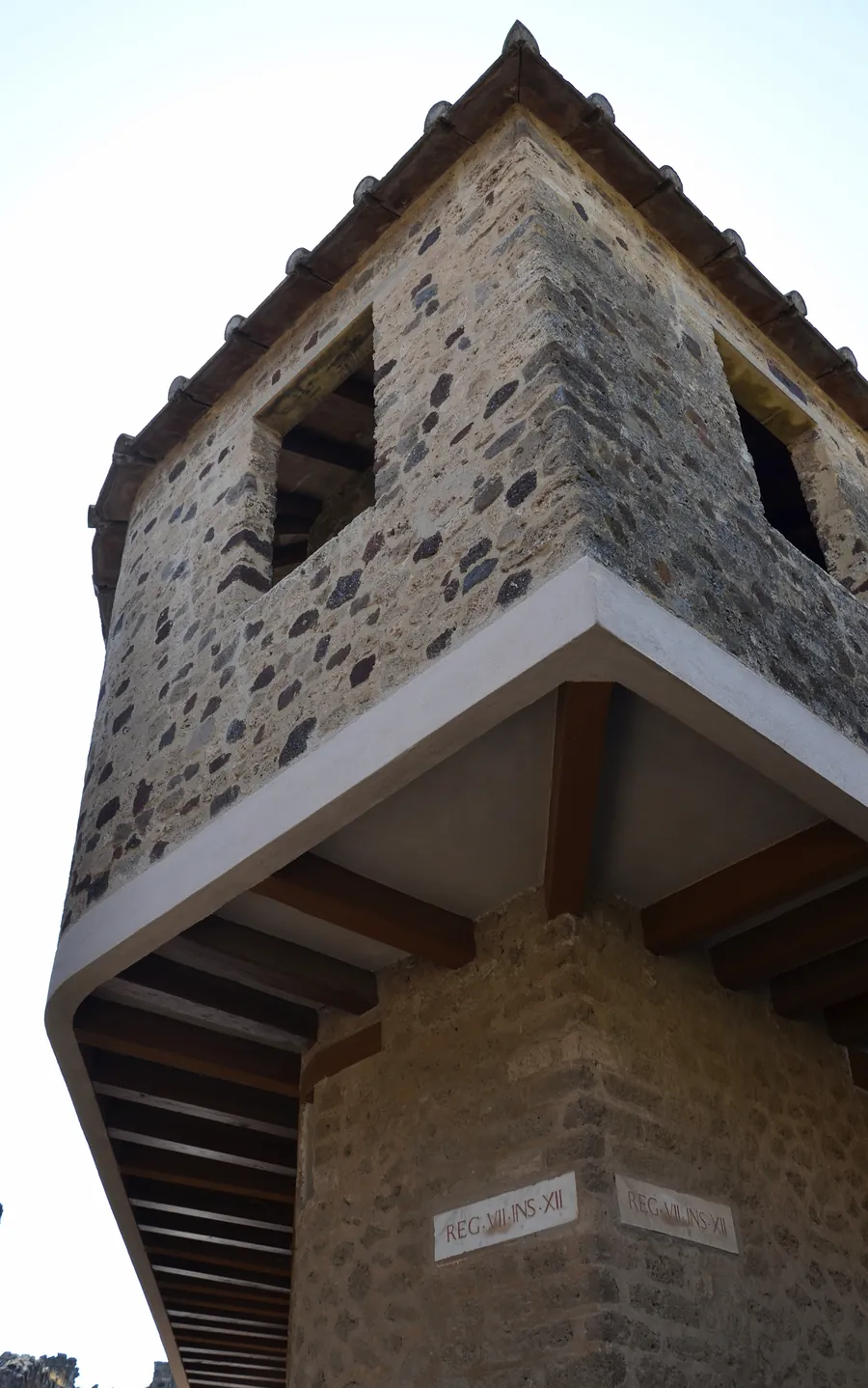 The corner of the brothel, its upper floor jutting over the street.