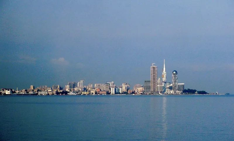 A row of tall towers on the seafront, seen from the water