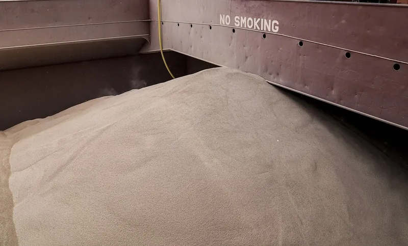 A heap of grain in the steel hold of a ship