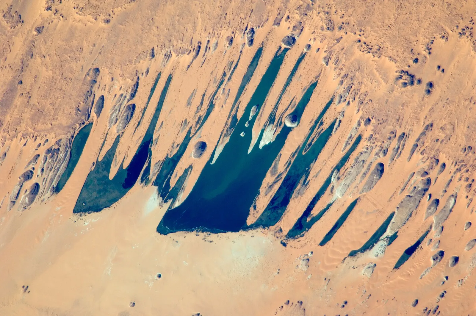 The Ounianga lakes of northern Chad from space: blue-green lakes among reddish dunes.