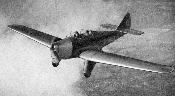 Period photograph: a Miles Hawk sport plane in flight, with two open cockpits.