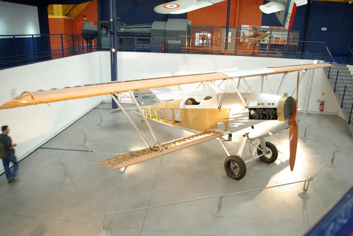 Potez 25 biplane with partly uncovered fuselage on museum display, seen from above, with an orange propeller.