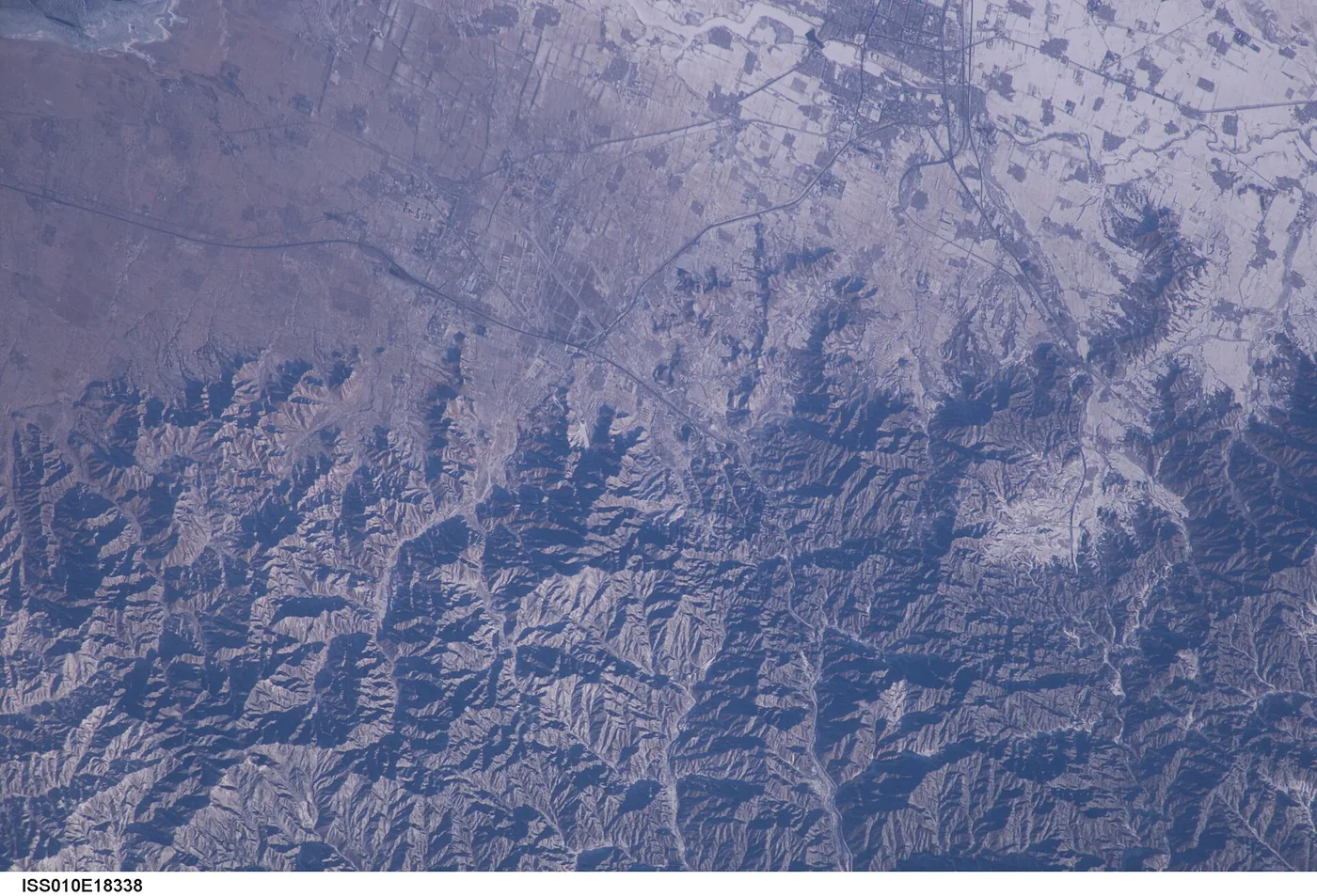 Photograph from space: mountains and plains of China, seen from the space station