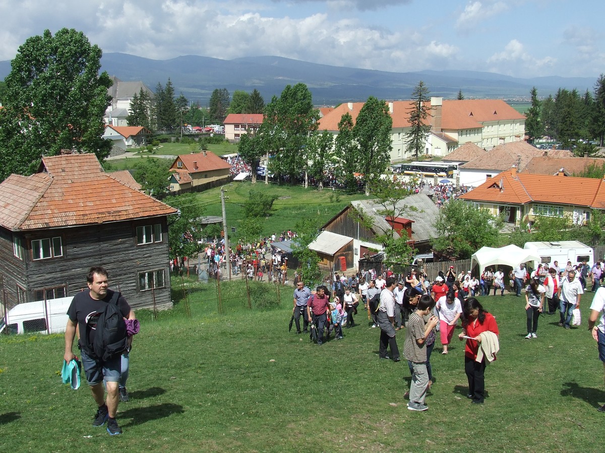 Pilgrims on the hillside on feast day, with the monastery in the valley.