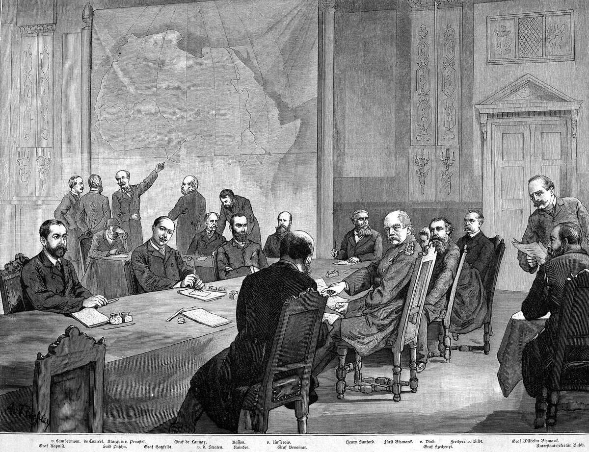 Engraving of delegates seated around a long table in a high hall, with a large wall map of Africa behind them.