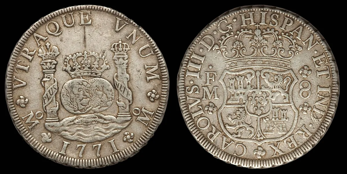 Both faces of a silver coin: two globes between pillars on one side, a crowned Spanish shield on the other.