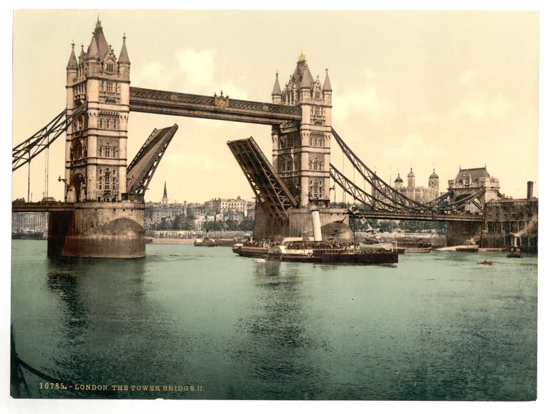 Tower Bridge with both bascules raised, a steamer passing beneath